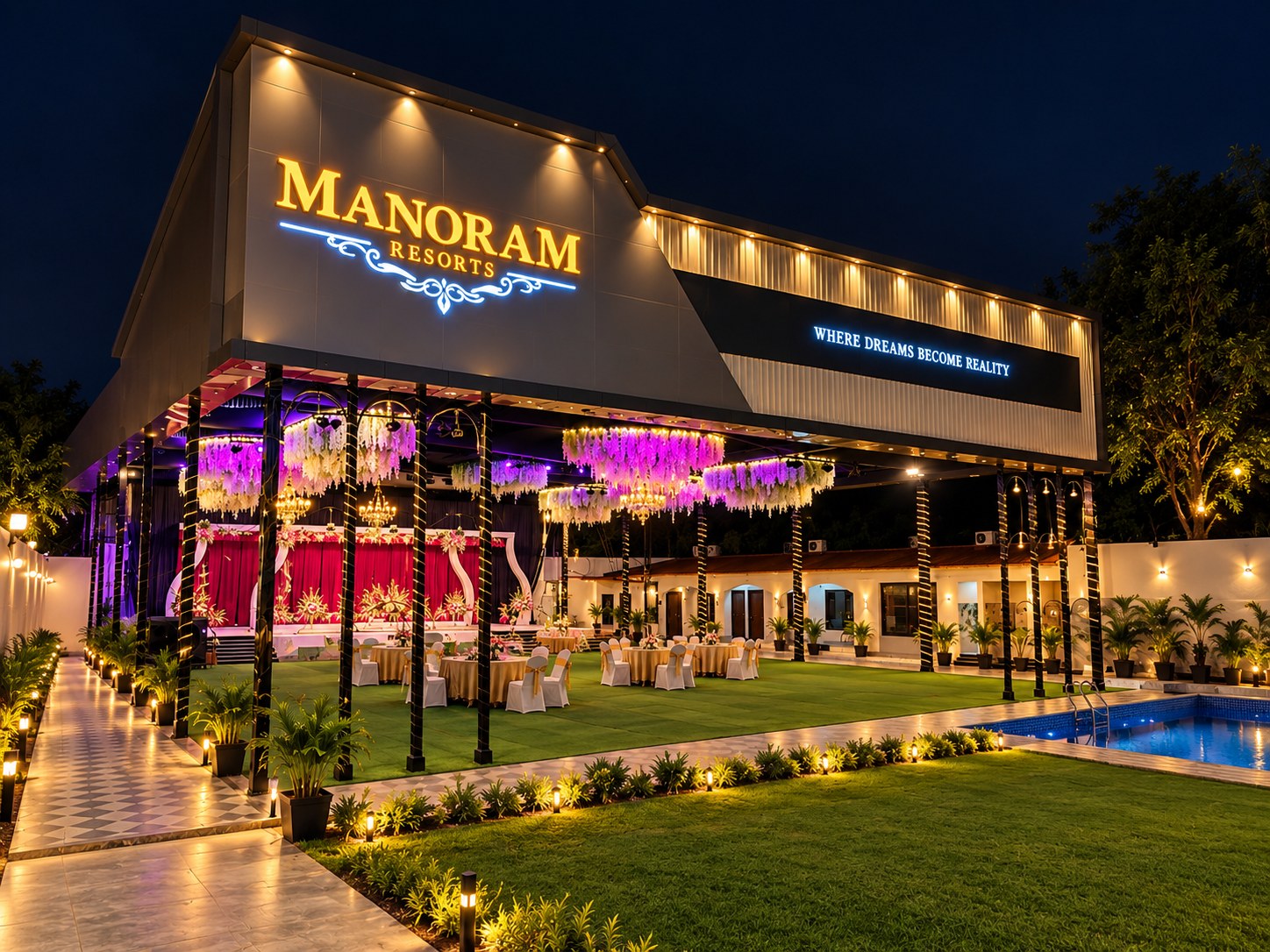 Manoram Resorts illuminated facade at night with lawn set up for a celebration