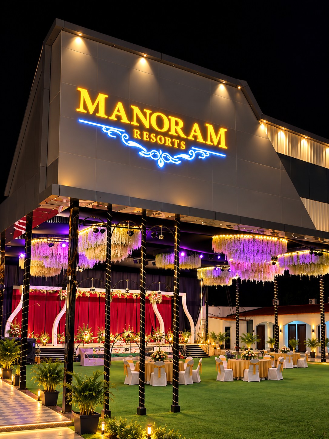 Manoram Resorts facade and lawn illuminated at night