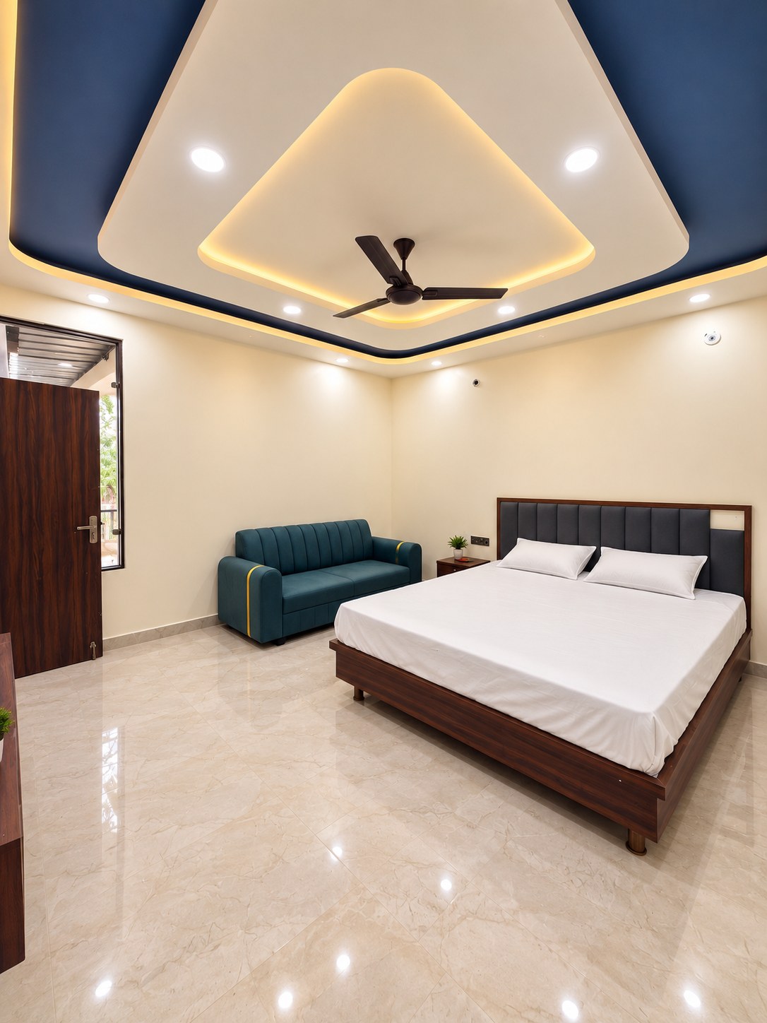 Spacious luxury bedroom with marble flooring at Manoram Resorts